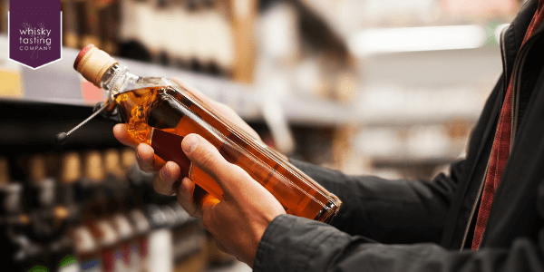Man choosing a good Scotch whisky