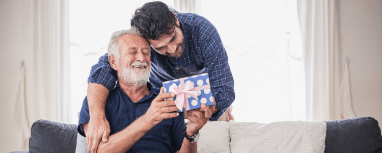 Son giving his dad a whisky gift set